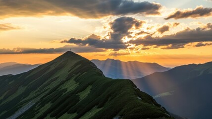 A mountain peak with a cross at sunset with sun rays shining through the clouds in the background