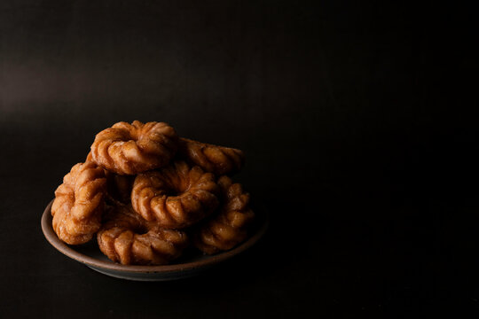 Stack of donuts on pottery plate 