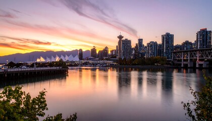 Naklejka premium City skyline reflected in calm water at sunset