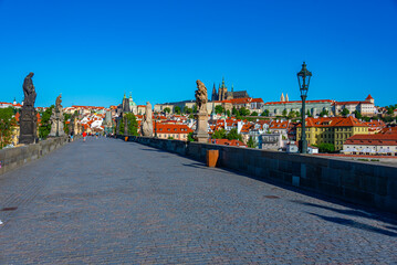 Obraz premium People are passing Charles bridge in Prague, Czech republic