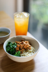 Mie ayam. Noodle with chopped chicken and boiled vegetable. served with chicken broth.
