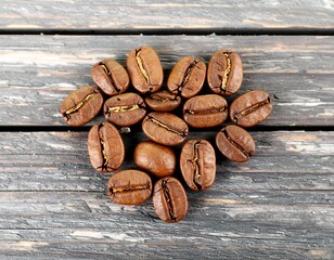 Coffee beans arranged in a heart shape on wood