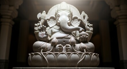 Fototapeta premium Close-up of a white stone Ganesha statue in a temple with dramatic lighting