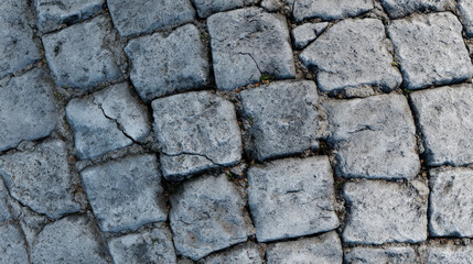 Obraz premium Worn gray cobblestone texture with rough edges and dirt, ideal for aged pavements and natural outdoor 3D environments