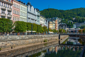 Fototapeta premium Colourful houses reflecting on Tepla river in Karlovy Vary, Czec