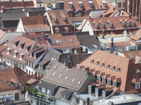Geometric red tile rooftops overlapping historic Nuremberg cityscape