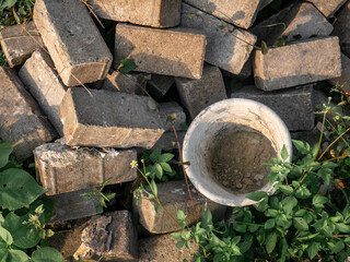a Bucket and Pile of Bricks that are no longer used