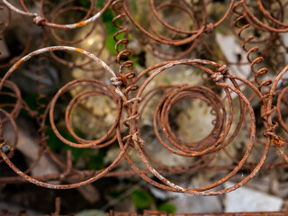 Rusty metal from part of bed springs, close up view of unique structure