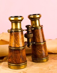 Antique binoculars on aged parchment