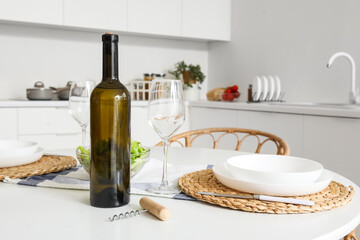 Served dining table in interior of light kitchen
