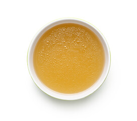 Bowl of tasty vegetable broth on white background