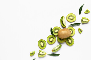 Slices of fresh kiwi and leaves on white background