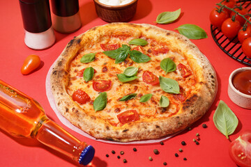 Tasty pizza Margarita with tomatoes and basil on red table