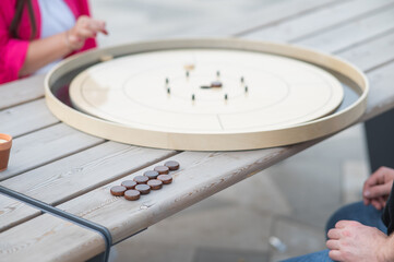 Strategic Game Pieces on a Wooden Board crokinole. 