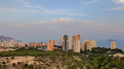 Fototapeta premium The stunning Coastal City Skyline at Sunset beautifully complemented by Lush Greenery all around