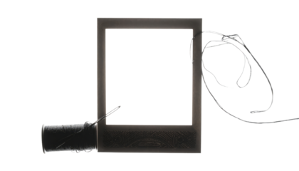 Blank photographic slide frame with attached wires.