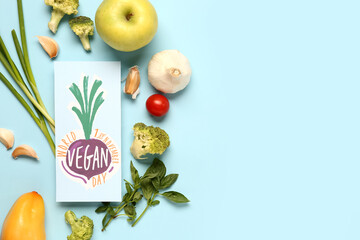 Card with text WORLD VEGAN DAY, fresh fruits and vegetables on blue background