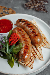 Grilled tasty bratwurst sausages on the plate