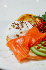 Summer healthy fastfood lunch, breakfast with Pancake with red fish, avocado and egg for breakfast. Aesthetic still life, healthy food concept