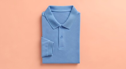 Folded Blue Polo Shirt on Peach Background Casual Apparel