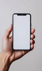 Person Holding a Smartphone with Blank Screen in Hand on Gray Background
