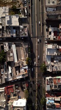 Aerial view of vehicles on the avenue. Tracking from a top-down angle. Long Adolfo L&oacute;pez Mateos Avenue in Aguascalientes, Mexico. In the city center.