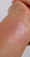 Shimmering blush swatched on fair skin