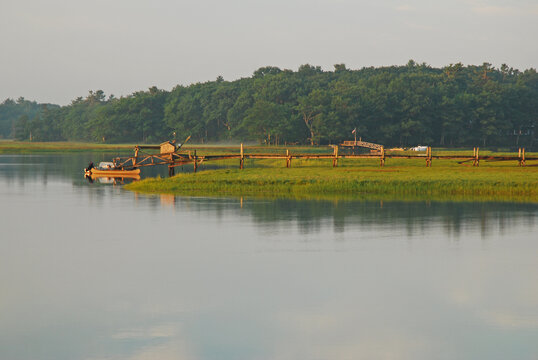 A mist lingers over a New England coast marshland in the morning