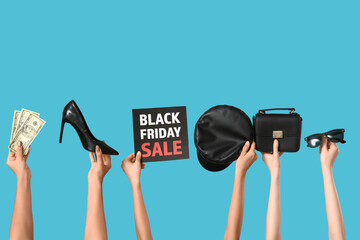Hands with money and accessories on blue background. Black Friday sale