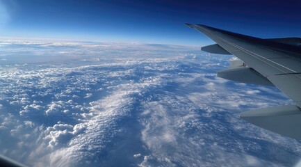 High-altitude view of clouds and wings