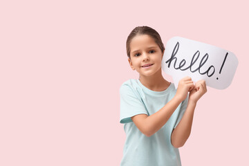 Cute little happy girl holding paper speech bubble with word HELLO on pink background