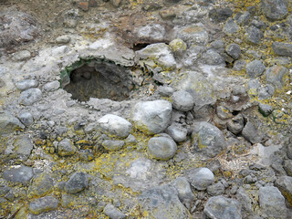 Fumarole in volcanic landscape with yellow sulphur deposits on Baransky volcano on Iturup, Kuril islands