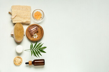 Set of cosmetic products for anti-cellulite massage and palm leaf on white background