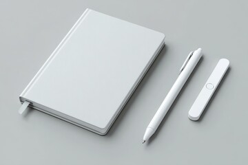 Minimalistic White Notebook with Pen and Stylus on Grey Background in Modern Workspace Arrangement
