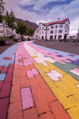Rainbow colored street in the picturesque town of Isafjordur Iceland located in the Westfjords region.
