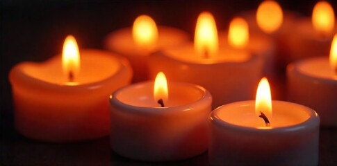 Close-up of several flickering candle flames, warm light illuminating the wax, creating a cozy and inviting atmosphere  Perfect for holiday, relaxation, or spiritual themes ,  cozy,  christmas