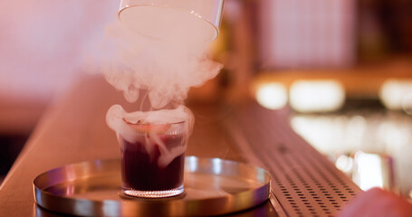 Drink presentation. Cocktail fume. Glass cap cloche cold smoke removing from alcoholic beverage. Making vapor aperitif on pub counter.