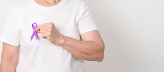 Elderly with Purple Ribbon for Violence, Pancreatic, Esophageal, Testicular cancer, Alzheimer, Epilepsy, Lupus, Crohn, Thyroid,  Sarcoidosis and Fibromyalgia. Awareness month and World cancer day