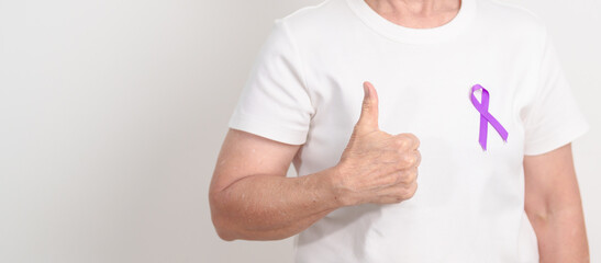 Elderly with Purple Ribbon for Violence, Pancreatic, Esophageal, Testicular cancer, Alzheimer, Epilepsy, Lupus, Crohn, Thyroid,  Sarcoidosis and Fibromyalgia. Awareness month and World cancer day