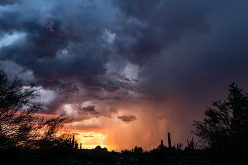 Lightning at sunset in the sonoran desert with colorful clouds