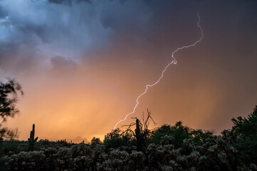 Lightning at sunset in the sonoran desert with colorful clouds