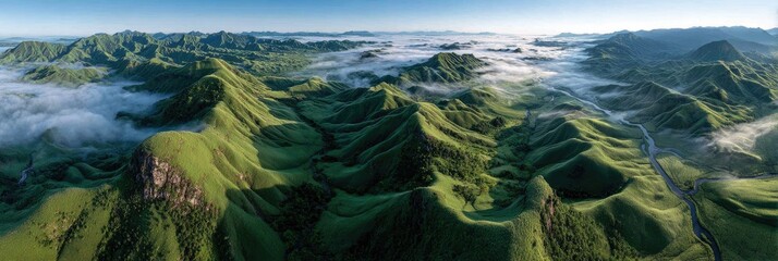 Panoramic view of rolling hills, lush green valleys, and morning mist
