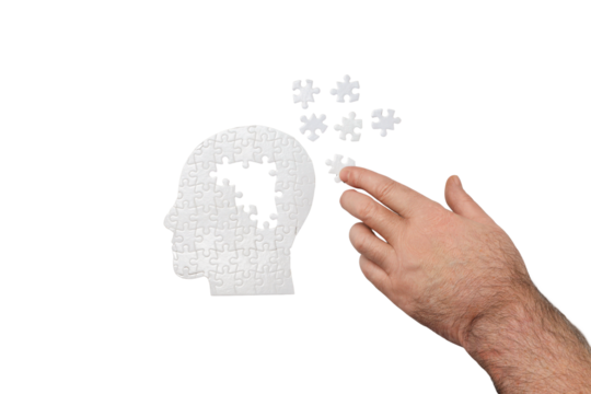 Hand fits puzzle pieces into head shape, isolated on white, PNG