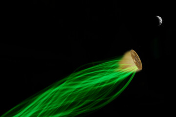A glowing Bitcoin coin with a green energy trail flying towards the moon, symbolizing the "To the Moon" concept in cryptocurrency.
