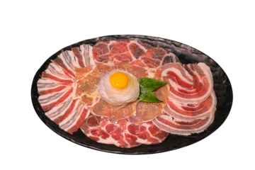 Delightful Culinary Presentation: A tantalizing platter showcases a diverse selection of thinly sliced raw meats, artfully arranged around an egg yolk, representing a gastronomic delight.