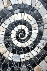 Elegant Spiral Mosaic Pattern of Black and White Stone Tiles