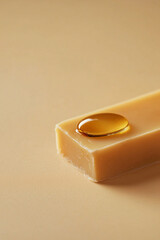 Natural Soap Bar with Honey Drop on Light Beige Surface