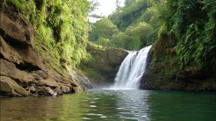 Fototapeta premium Serene waterfall cascading into a tranquil pool surrounded by lush green foliage in a tropical paradise