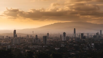 Obraz premium Panoramic City Skyline with Mountains at Golden Hour Sunset