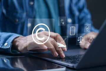 Copyright law concept. Protecting intellectual property, businessman using laptop with copyright...